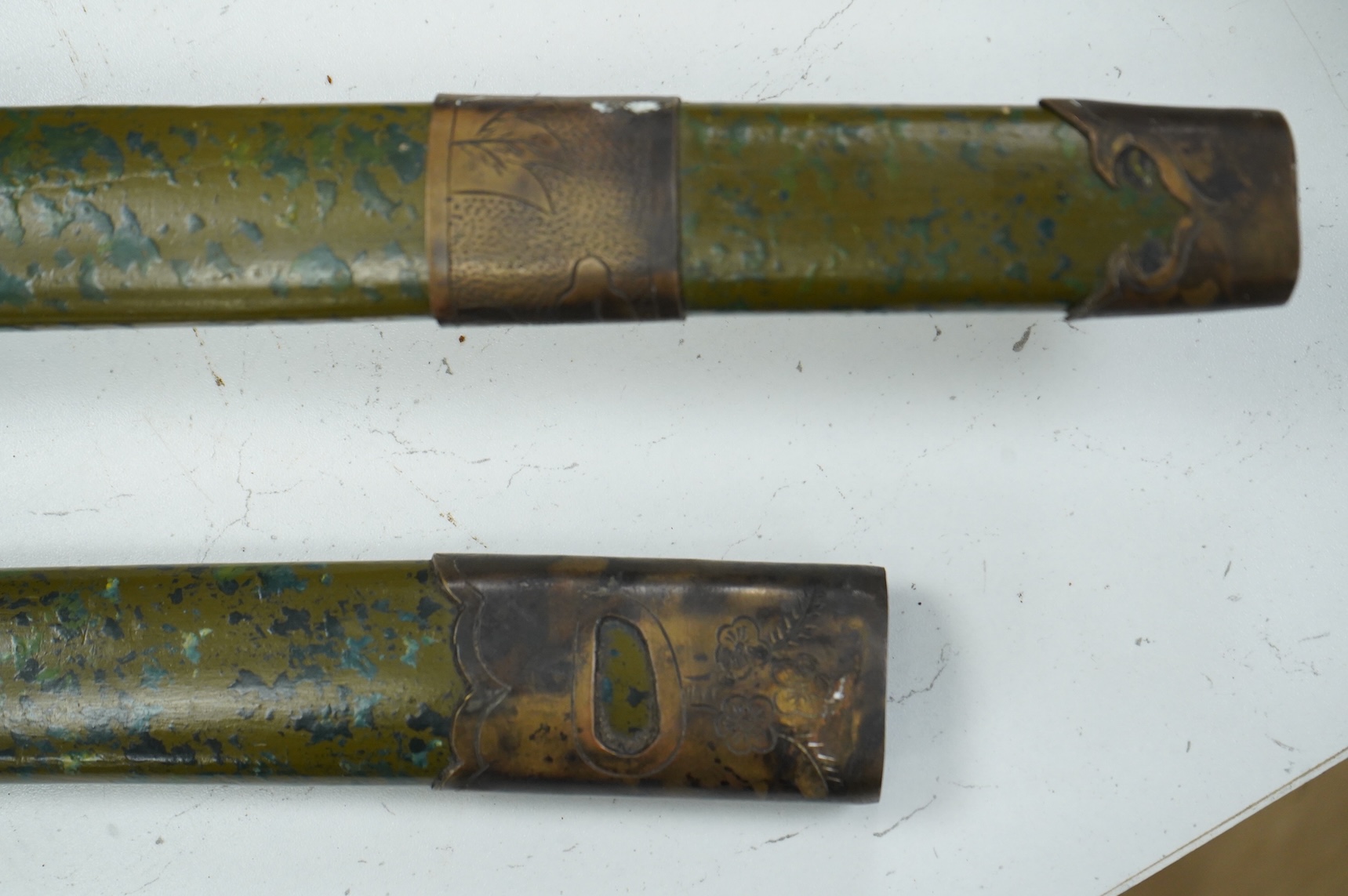A well-made Chinese copy of a Japanese sword katana, blade etched with wood grain imitation, green painted handle, scabbard with engraved brass mounts